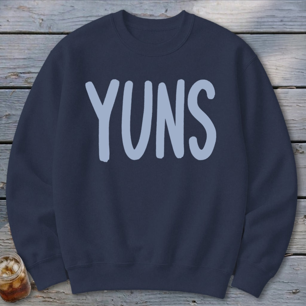 Dark blue sweatshirt with "YUNS" text in light blue.