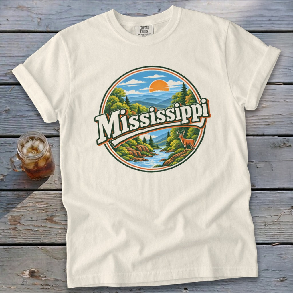 Cream t-shirt with "Mississippi" graphic featuring mountains, river, trees, and deer.