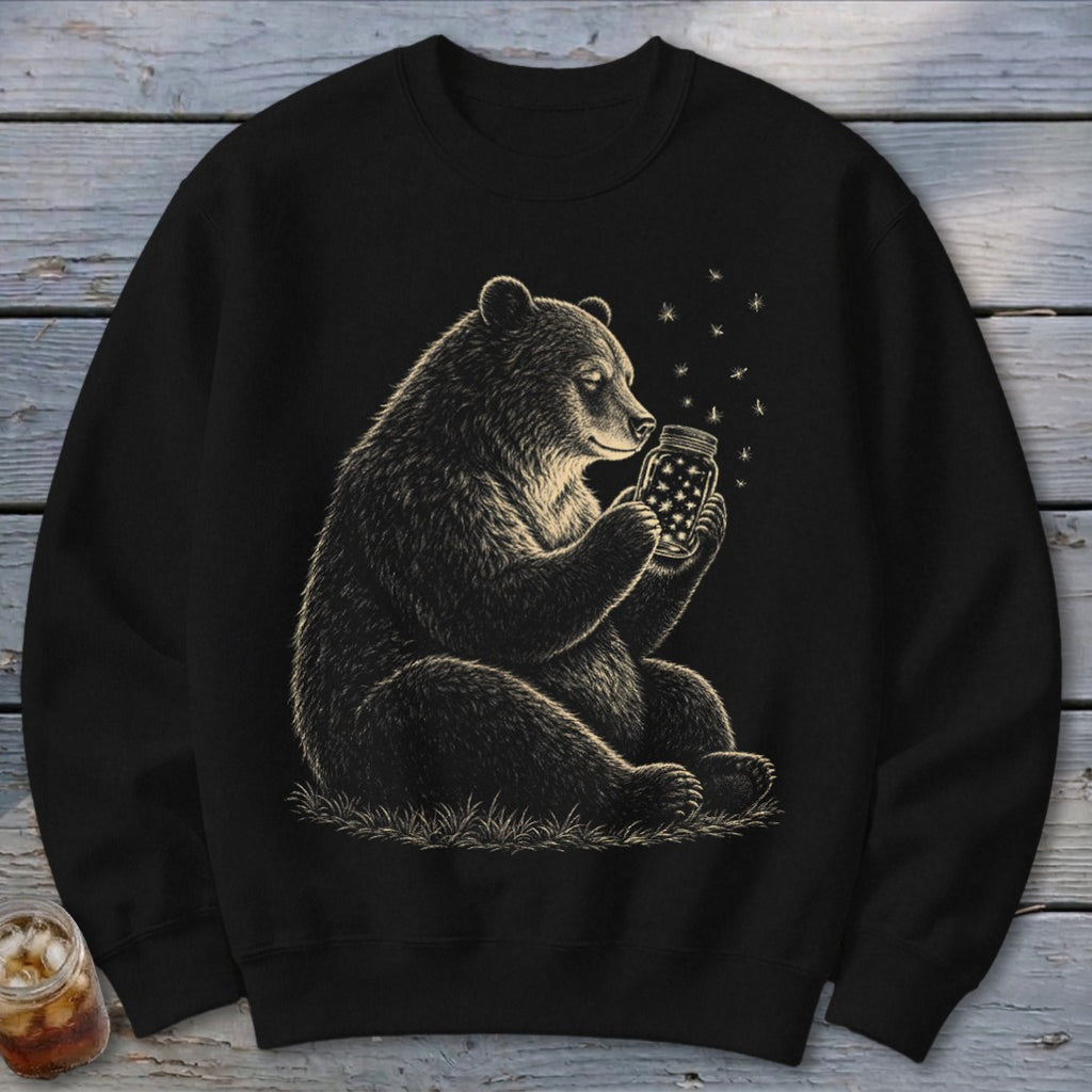 Black sweatshirt with a drawing of a bear holding a jar of stars.