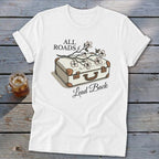 White t-shirt with a vintage suitcase, flowers, and the text "ALL ROADS Lead Back."