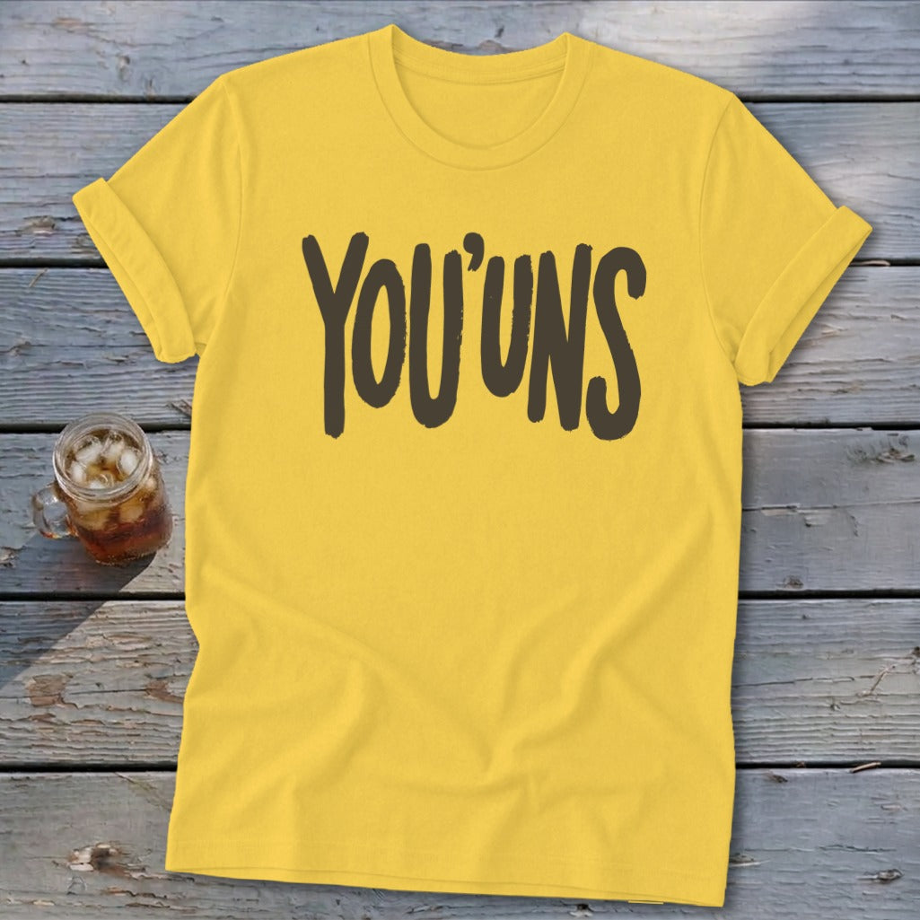 Yellow t-shirt with "YOU'UNS" in dark brown text.