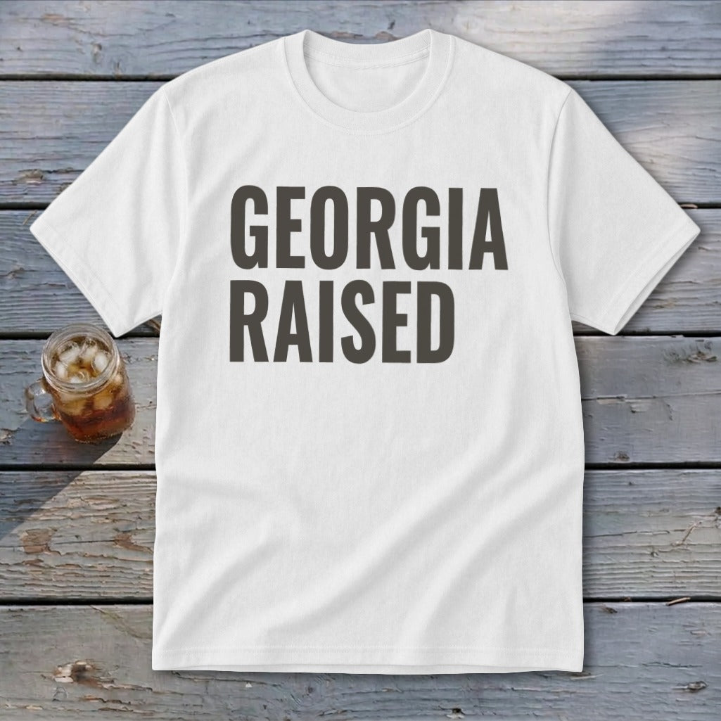 White t-shirt with bold dark gray text that reads "GEORGIA RAISED".