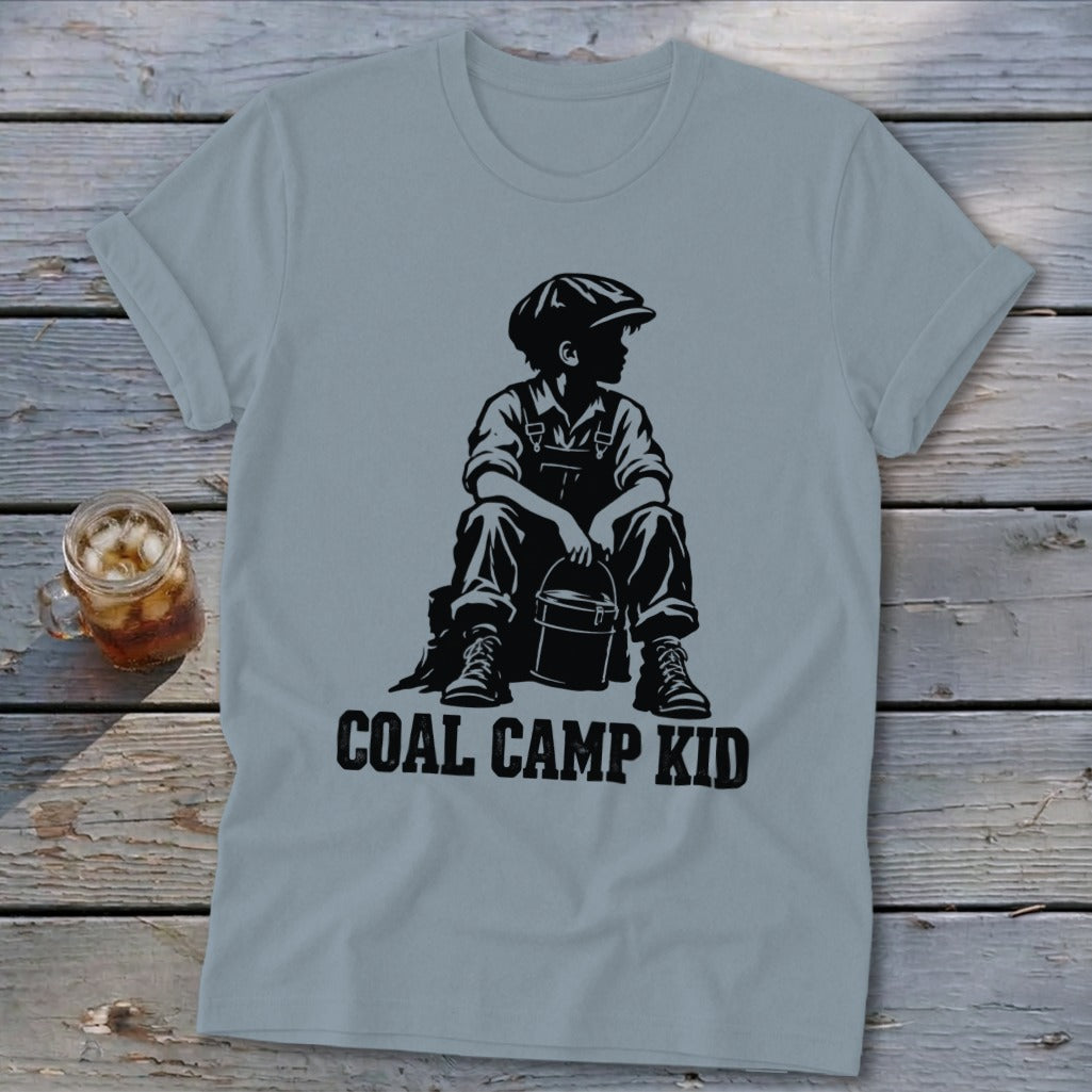 Light blue t-shirt with black graphic of a boy sitting with a bucket, text "COAL CAMP KID".