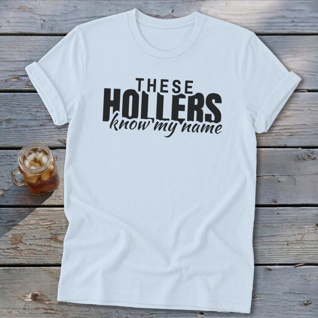 White t-shirt with black text "THESE HOLLERS know my name".