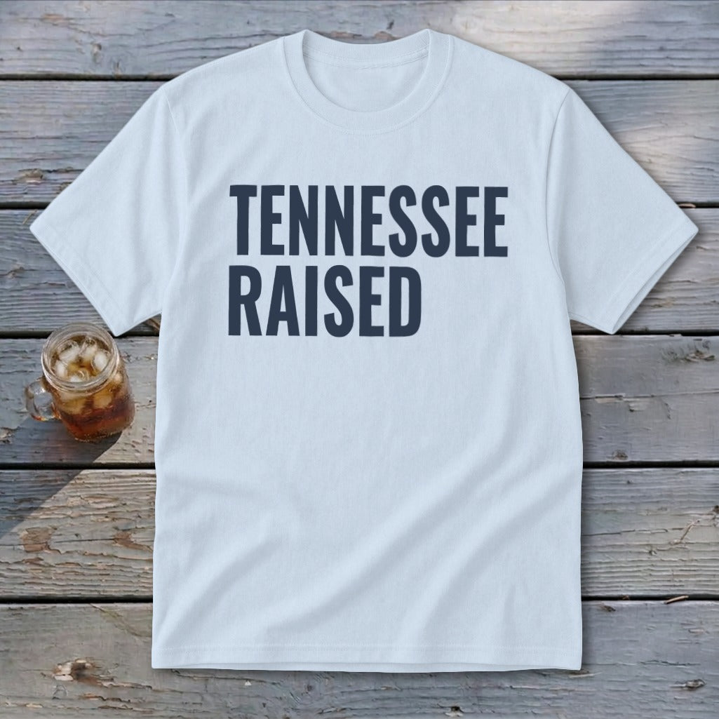 White t-shirt with navy blue text reading "TENNESSEE RAISED".