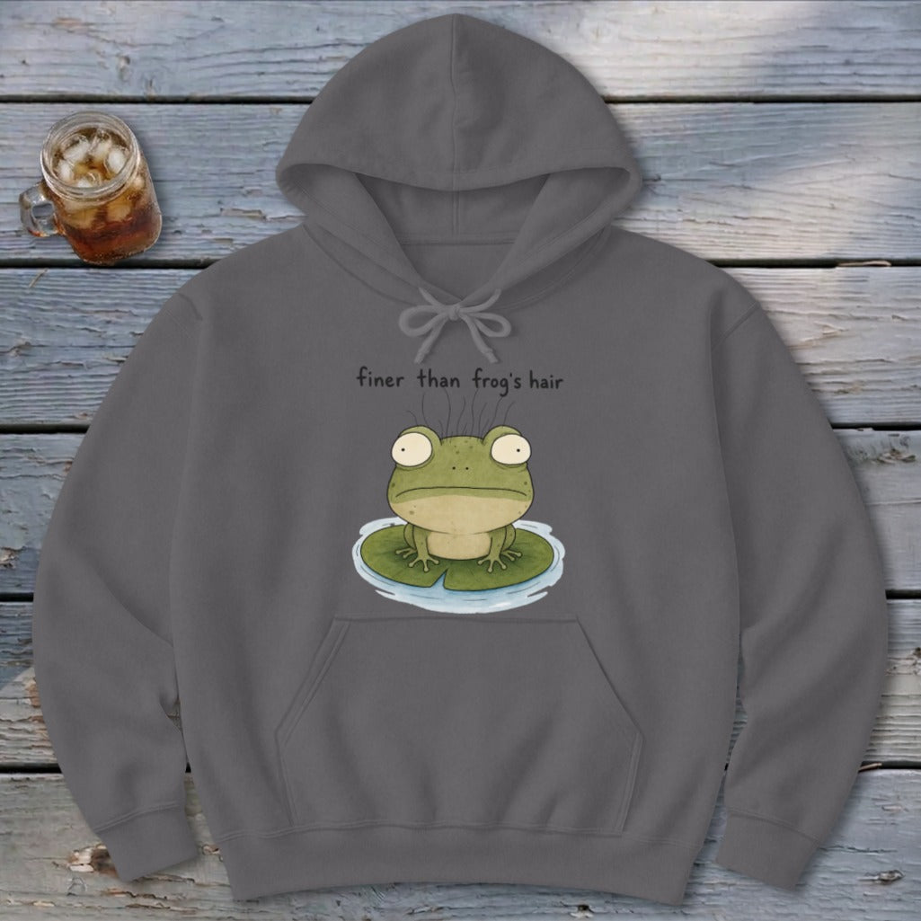 A grey pullover hoodie featuring a whimsical cartoon frog on a lily pad with the text finer than frog's hair.
