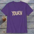 Purple v-neck t-shirt with "YOUR'N" printed in tan text.