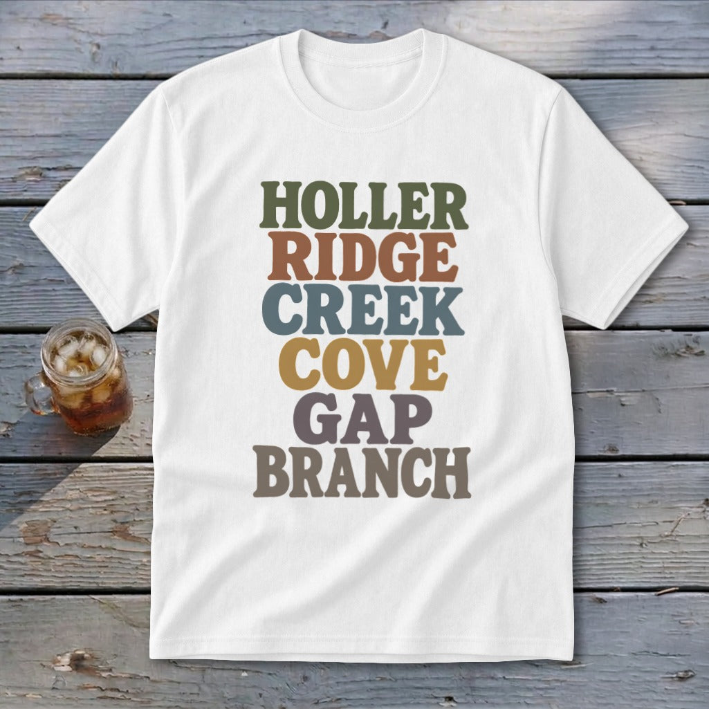 A white t-shirt featuring stacked, multi-colored retro typography spelling out HOLLER RIDGE CREEK COVE GAP BRANCH.