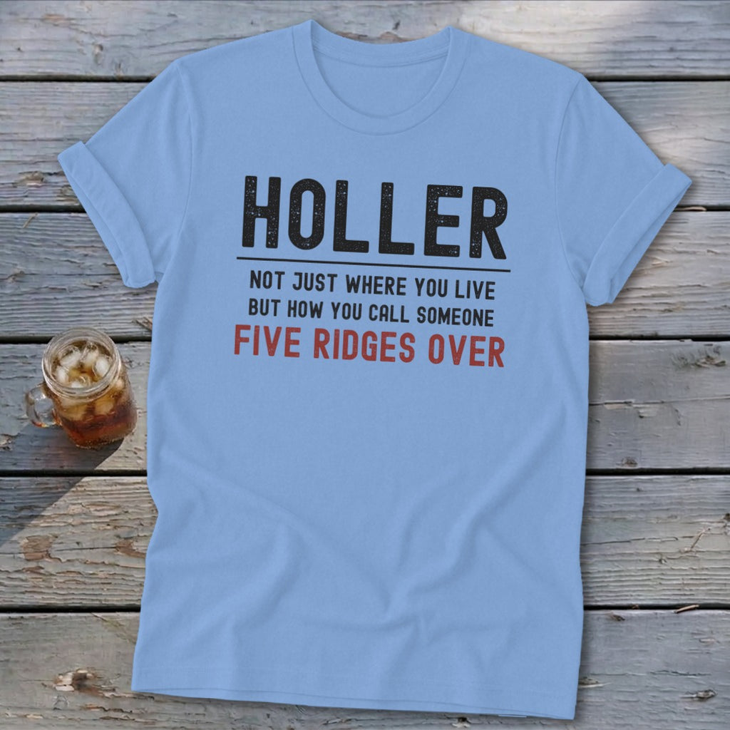 Light blue t-shirt with black text that reads "HOLLER NOT JUST WHERE YOU LIVE BUT HOW YOU CALL SOMEONE FIVE RIDGES OVER".