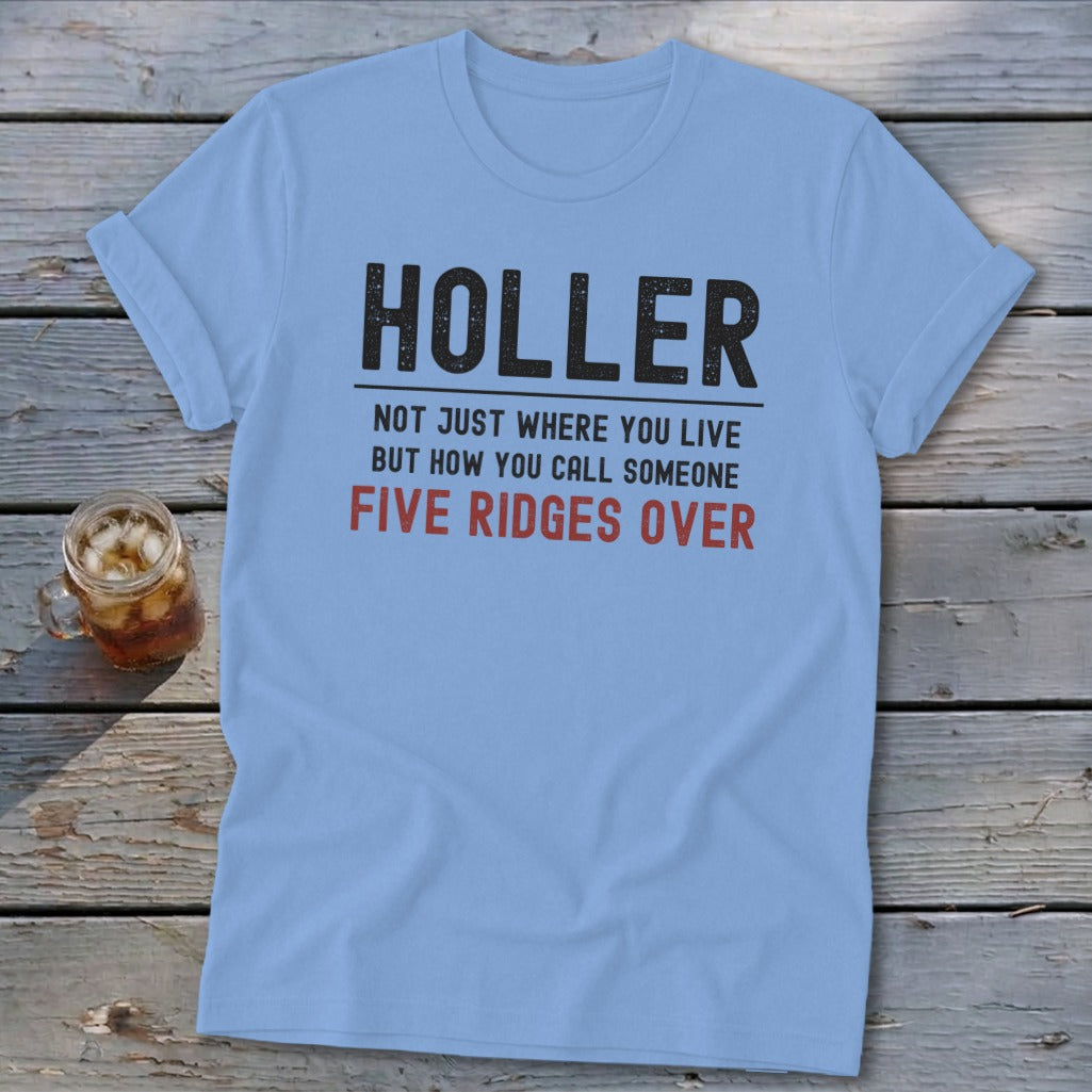 Light blue t-shirt with black text that reads "HOLLER NOT JUST WHERE YOU LIVE BUT HOW YOU CALL SOMEONE FIVE RIDGES OVER".