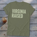 Olive green t-shirt with "VIRGINIA RAISED" printed in light tan text.