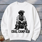 White sweatshirt with black graphic of a boy in overalls and cap holding a bucket, text reads "COAL CAMP KID".