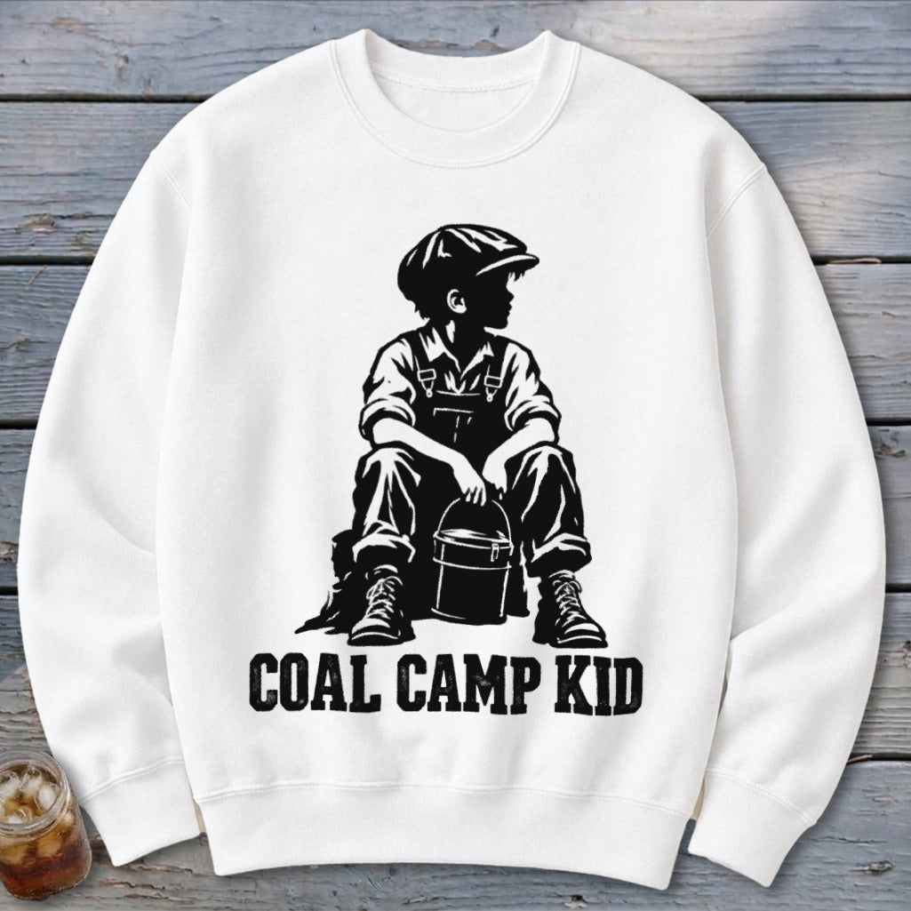 White sweatshirt with black graphic of a boy in overalls and cap holding a bucket, text reads "COAL CAMP KID".