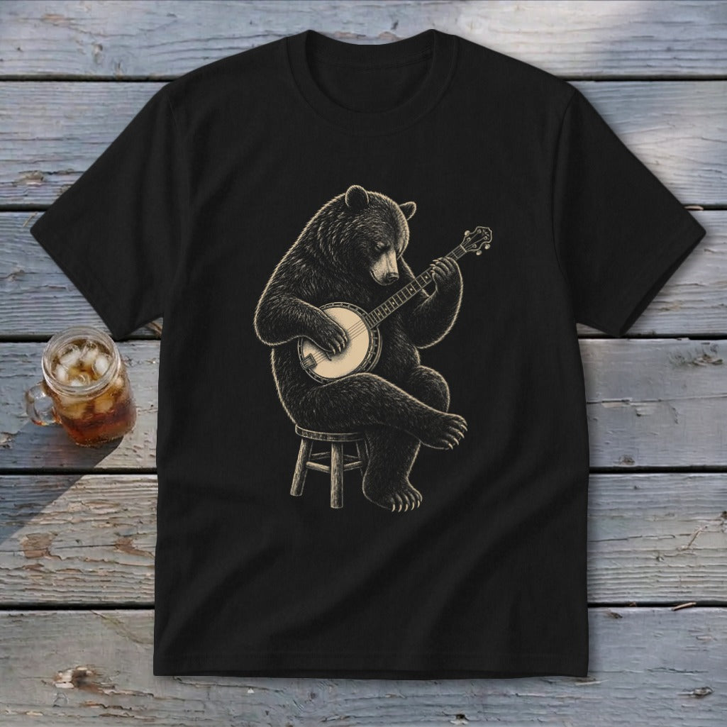 Black t-shirt with drawing of a bear playing a banjo sitting on a stool.
