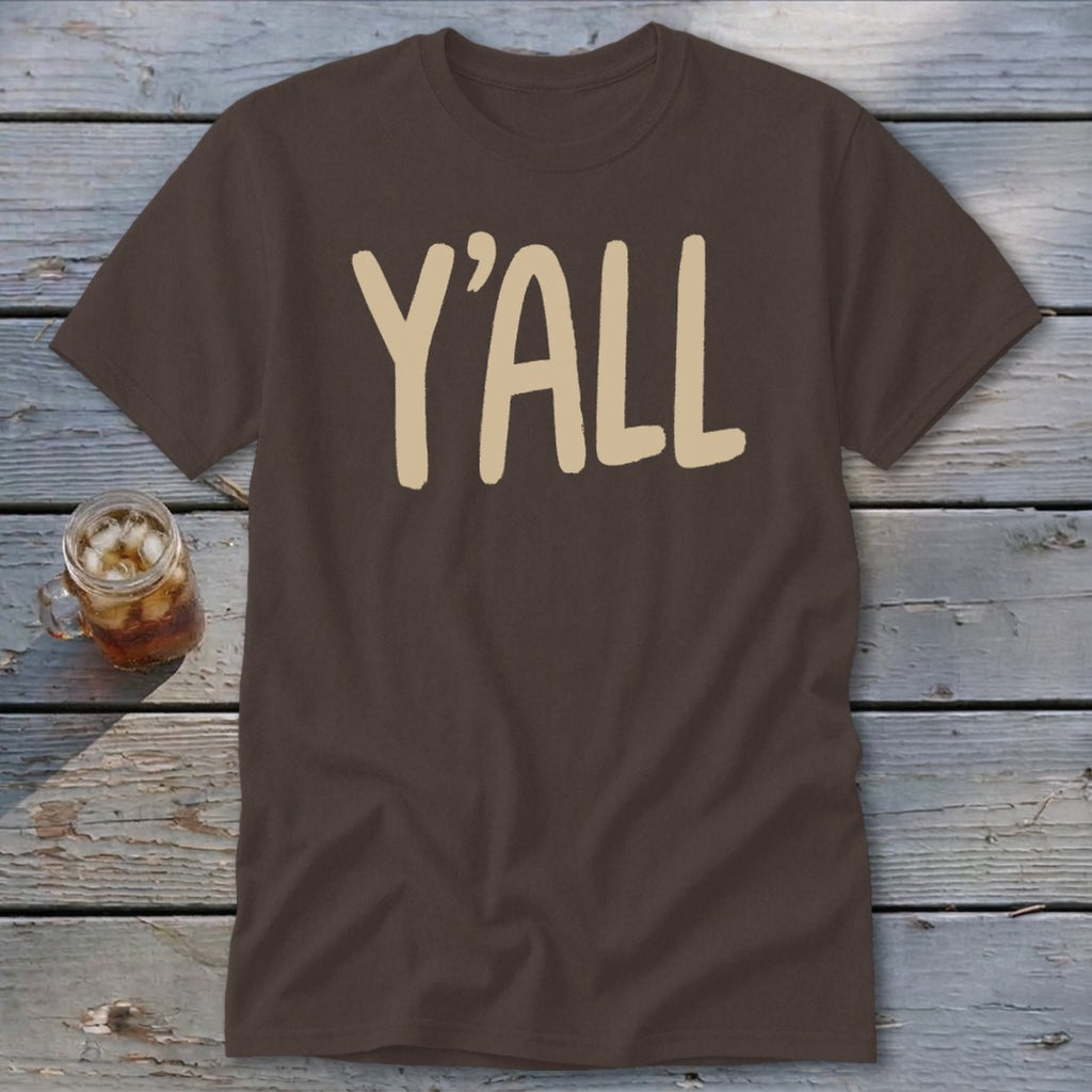 Brown t-shirt with "Y'ALL" in beige text, beside a glass of iced tea.