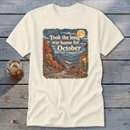 Cream t-shirt with text "Took the long way home for October" and autumn mountain scene.