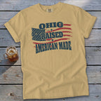 Tan t-shirt with "Ohio Raised American Made" and distressed American flag graphic.