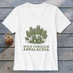 White v-neck t-shirt with green illustration of morel mushrooms and "Wild Foraged Appalachia" text.