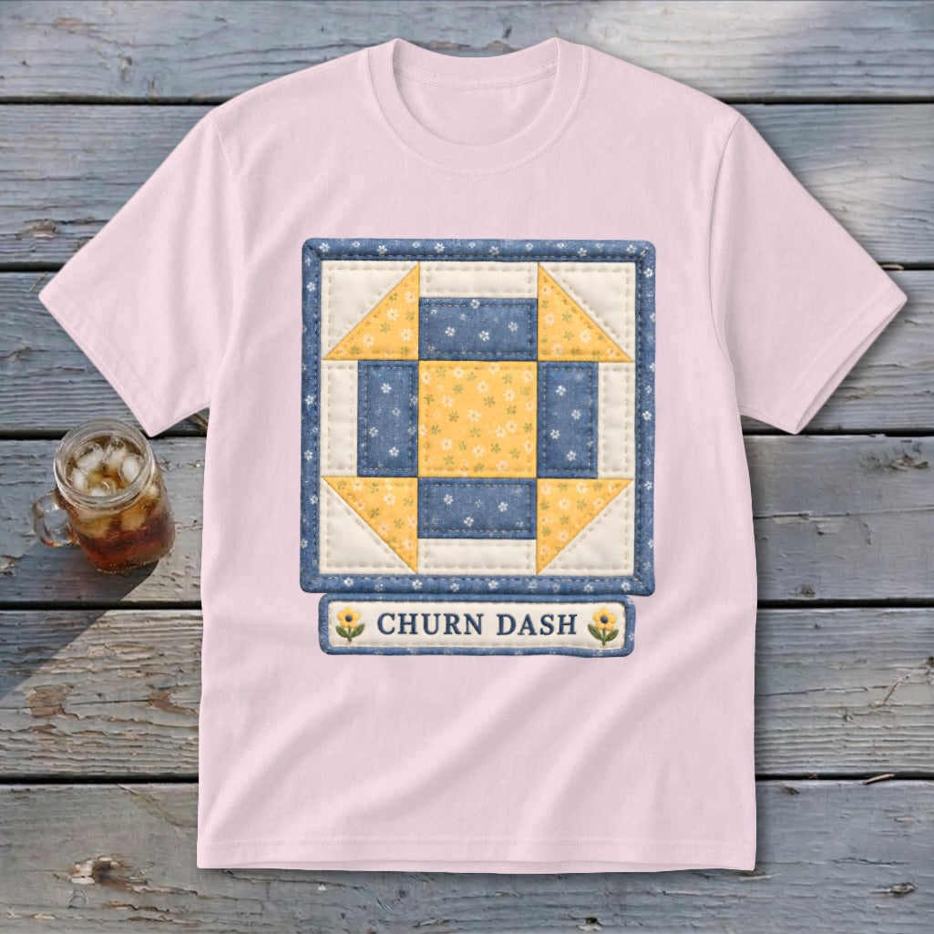 Pink t-shirt with a blue and yellow Churn Dash quilt square graphic.