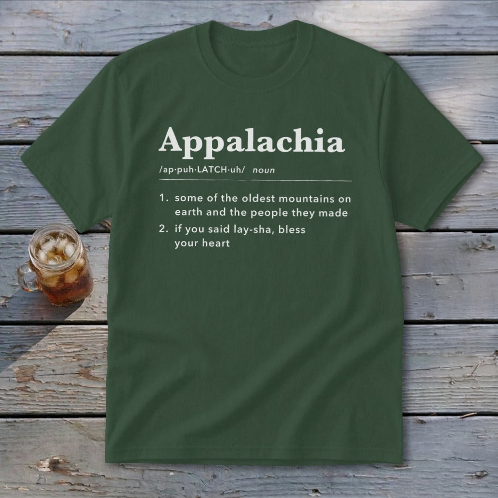 Dark green t-shirt with white dictionary-style definition text for Appalachia, laid flat on weathered wood.