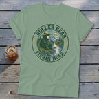 Green t-shirt with a circular graphic of a bear fishing with text "Holler Bear Fishin Hole."
