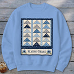 Light blue sweatshirt with a Flying Geese quilt pattern and text.