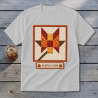 White t-shirt featuring a quilt square design of a maple leaf and the text "MAPLE LEAF".