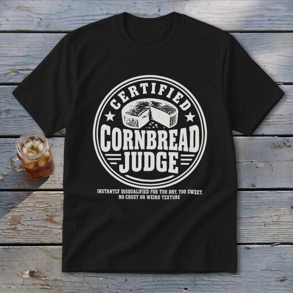 A black t-shirt features a circular white graphic with the text "Certified Cornbread Judge."
