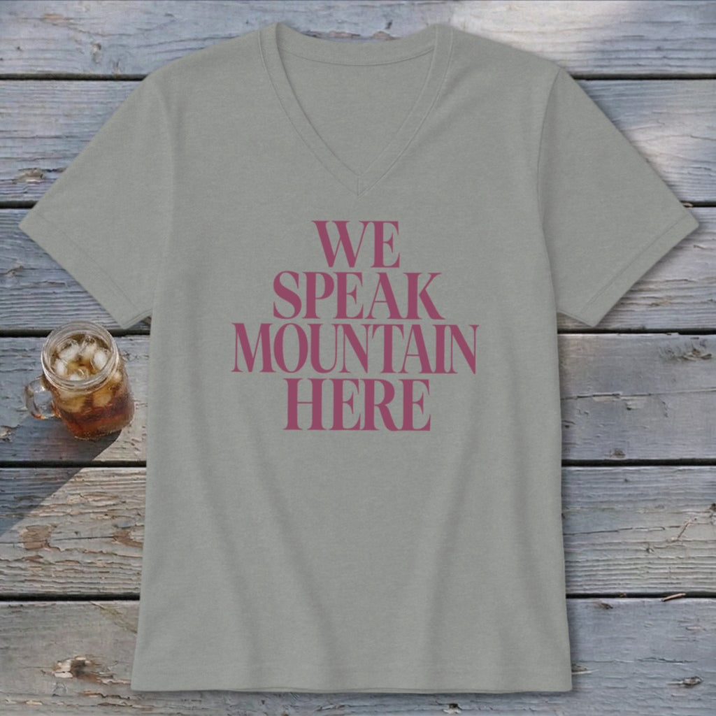 Gray v-neck t-shirt with pink text that reads "WE SPEAK MOUNTAIN HERE".