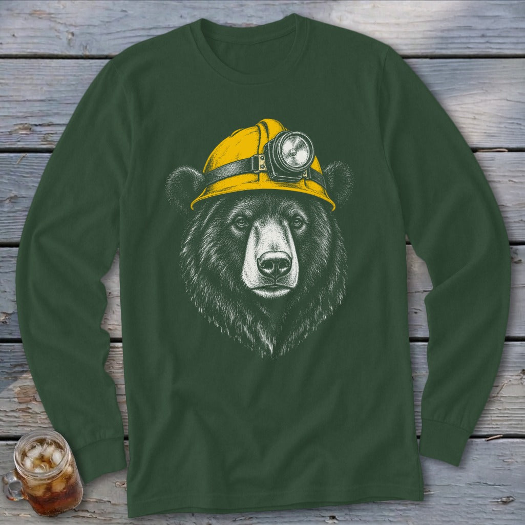 Black bear wearing a yellow hard hat with a headlamp on a green long-sleeve shirt.