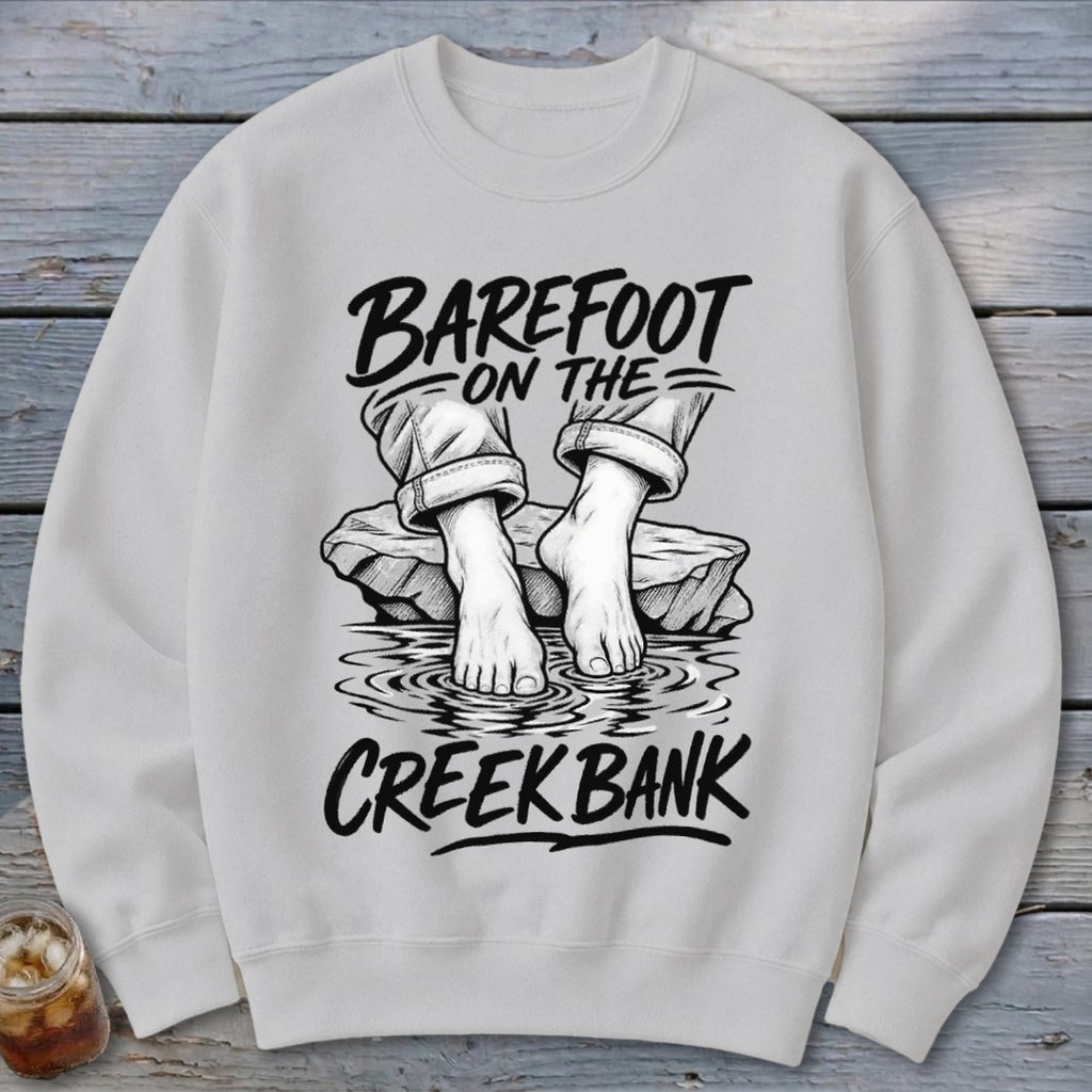 Light gray sweatshirt with "Barefoot on the Creek Bank" graphic and bare feet.