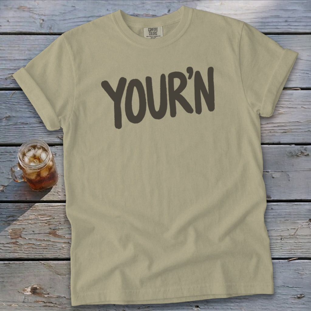 Tan t-shirt with "YOUR'N" in dark gray text.