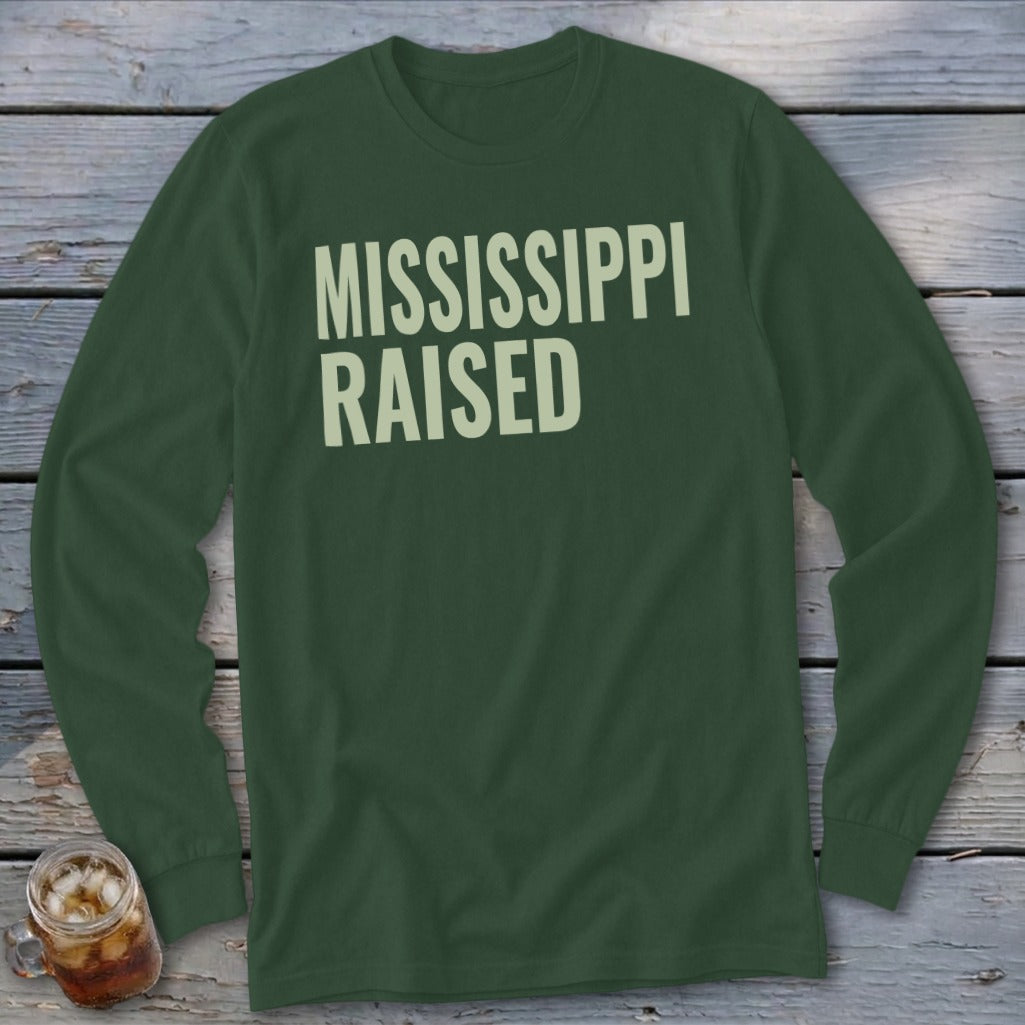 Dark green long-sleeve shirt with "MISSISSIPPI RAISED" text in cream.