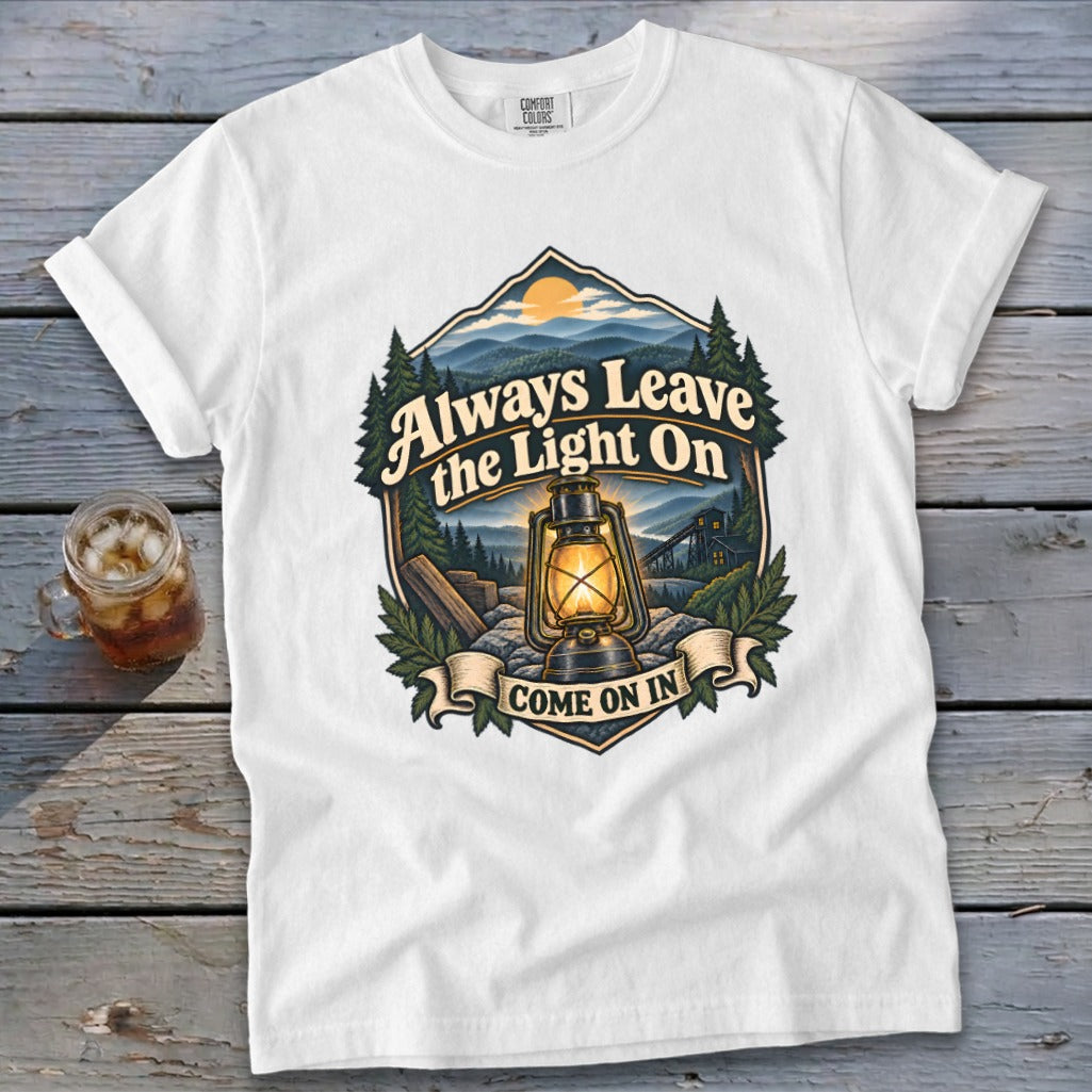 White t-shirt with "Always Leave the Light On Come On In" text and lantern graphic.