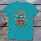 Turquoise t-shirt featuring a graphic of a winter toboggan hat with the text A toboggan is for my noggan.