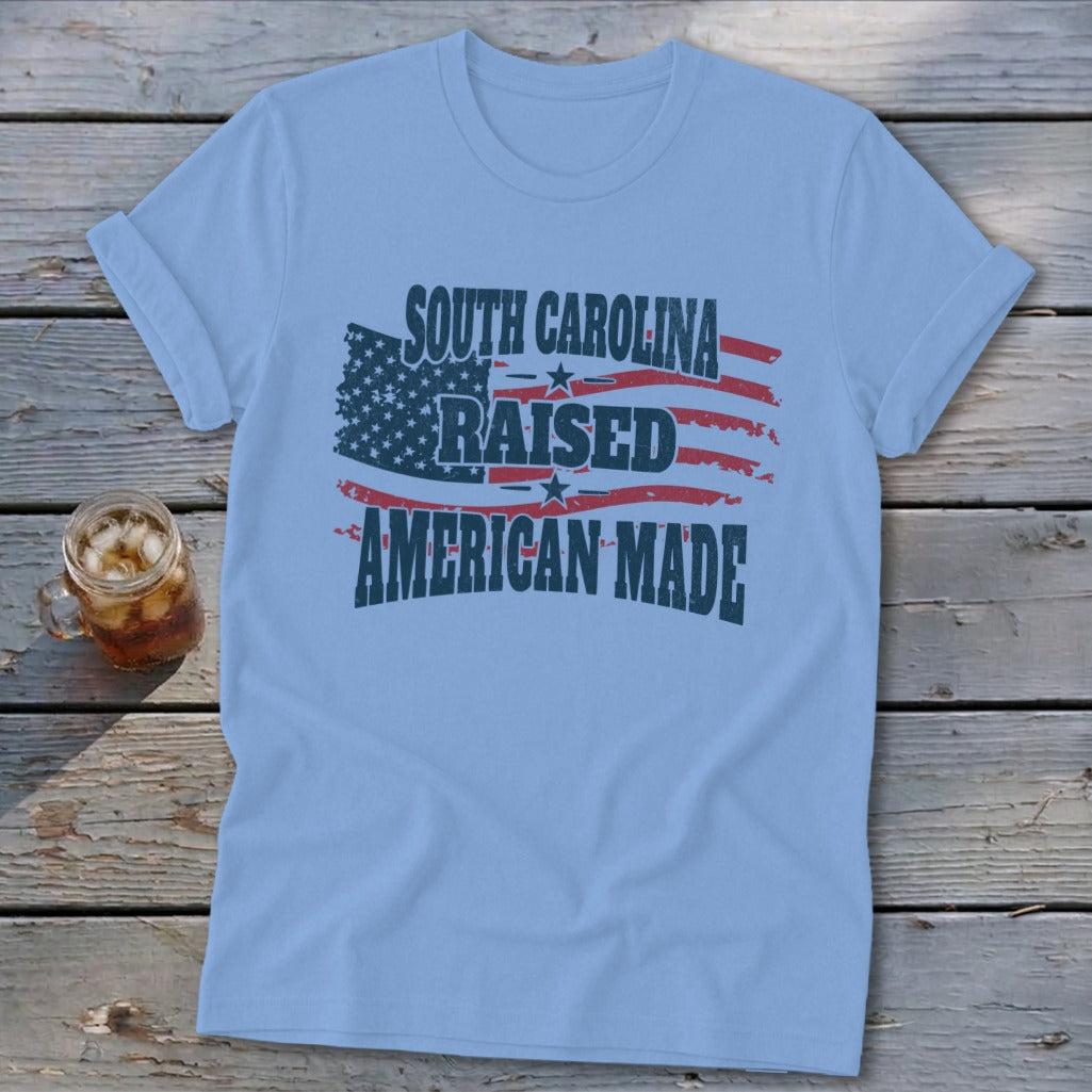 Light blue t-shirt with distressed American flag graphic and text.