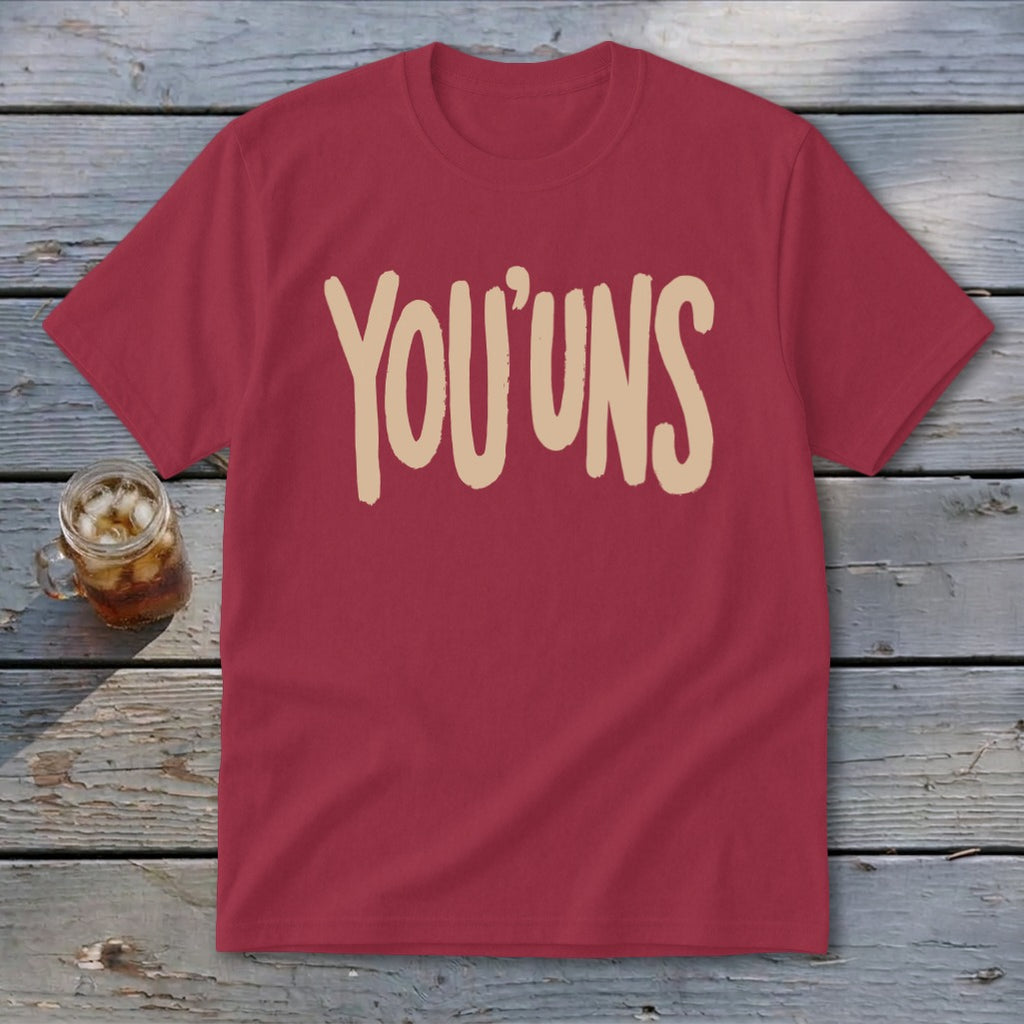 Maroon t-shirt with tan text that reads "YOU'UNS" and a drink.