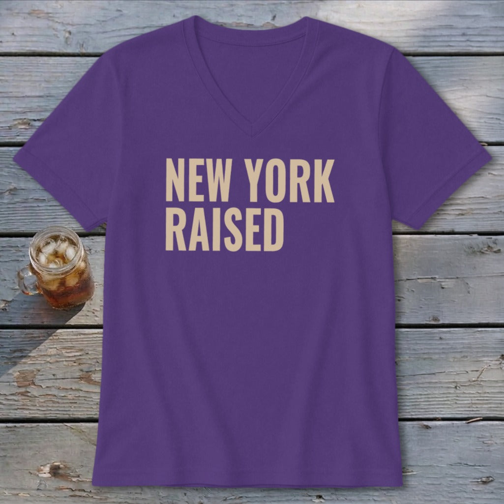 Purple v-neck t-shirt with "New York Raised" text.