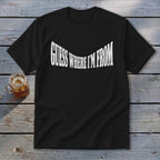 Black t-shirt with "GUESS WHERE I'M FROM" text in white, wavy font.