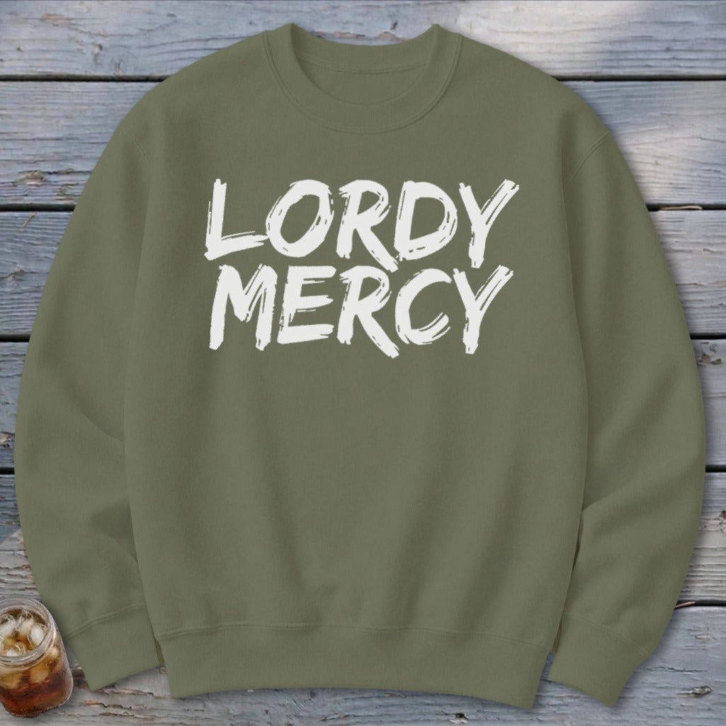Olive green crewneck sweatshirt with "LORDY MERCY" in white brush stroke lettering.