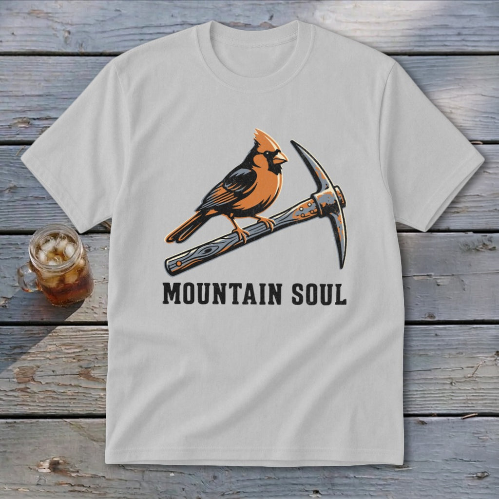 White t-shirt graphic of cardinal perched on a pickaxe with "MOUNTAIN SOUL" text.