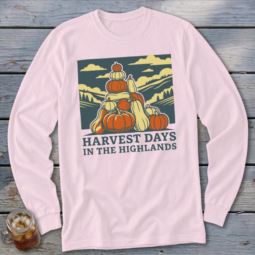 Light pink long-sleeve shirt featuring a stacked pumpkin illustration and the text Harvest Days in the Highlands.