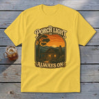 Yellow t-shirt with "The Porch Light Is Always On" text and cabin scene.