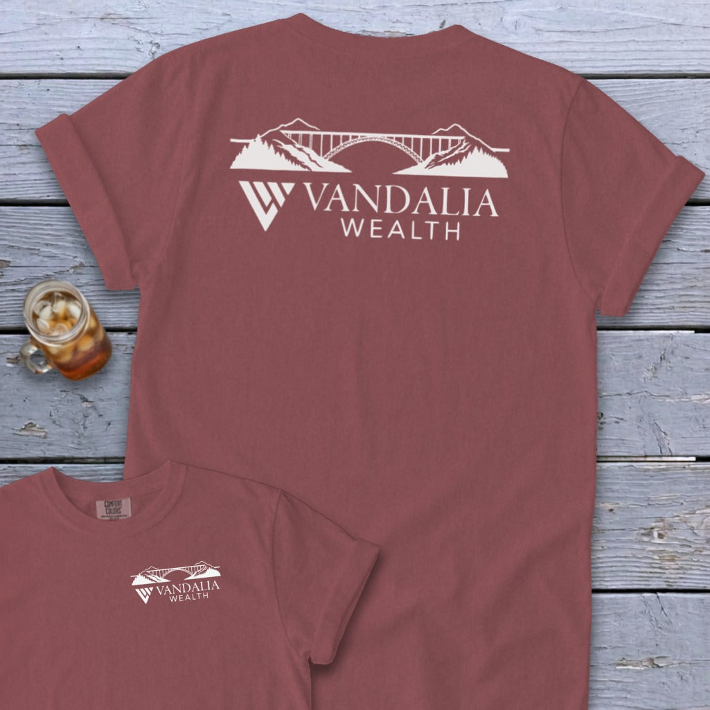 Maroon t-shirt with white bridge and mountain logo, "VANDALIA WEALTH" text.