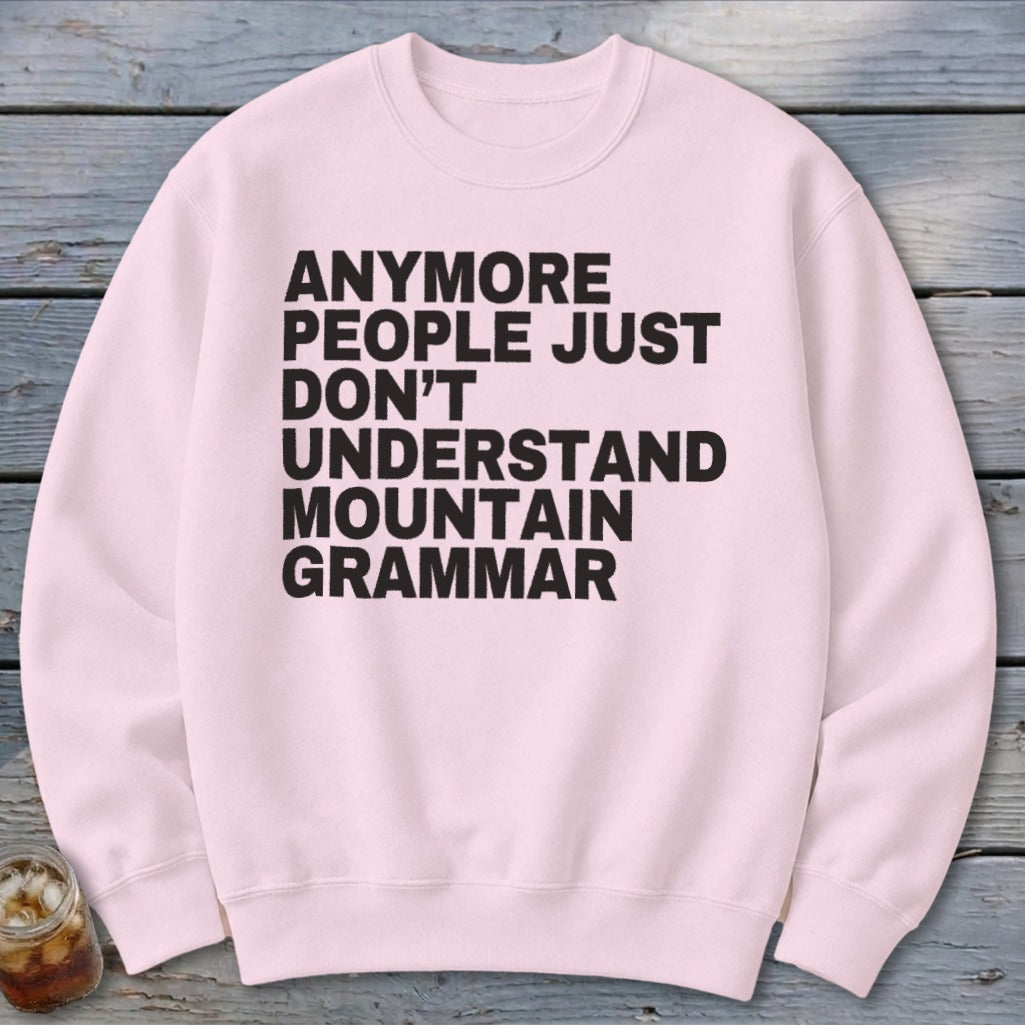 Pink sweatshirt with black text reading "Anymore people just don't understand mountain grammar."
