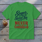 A green short-sleeve t-shirt with blue and red text stating Sugar in my Sweat Tea NEVER IN MY CORNBREAD.