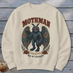 Cream sweatshirt with Mothman graphic, saying "MOTHMAN WAS MY NEIGHBOR".