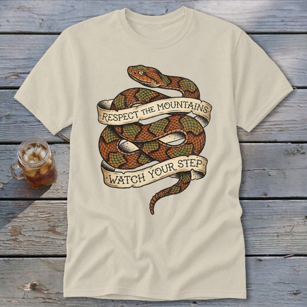 Cream t-shirt with coiled snake graphic and text: "Respect the Mountains, Watch Your Step."