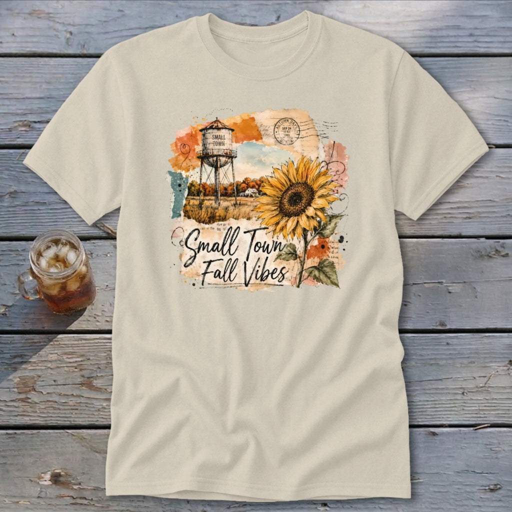 T-shirt graphic with water tower, sunflower, and text "Small Town Fall Vibes".