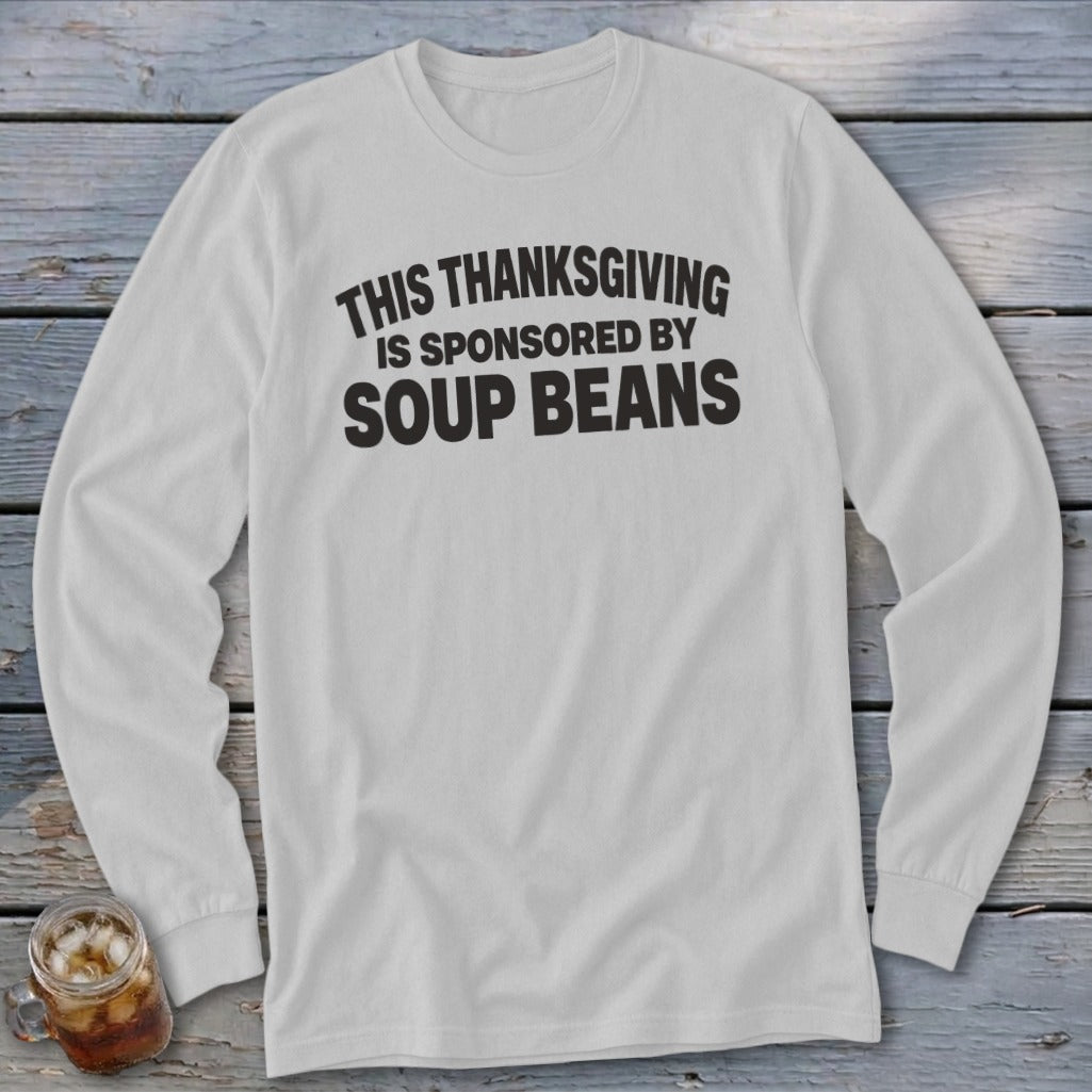 Light gray long-sleeve t-shirt with black text that reads, This Thanksgiving is sponsored by soup beans.